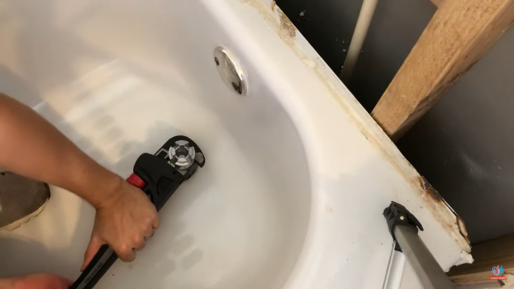 Rotate the drain remover using a wrench